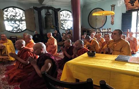 A group of people praying in a room

AI-generated content may be incorrect.